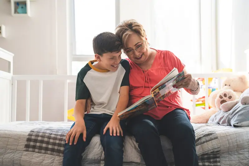A grandmother and grandson with a book
