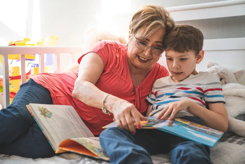 A grandmother reading with her grandson