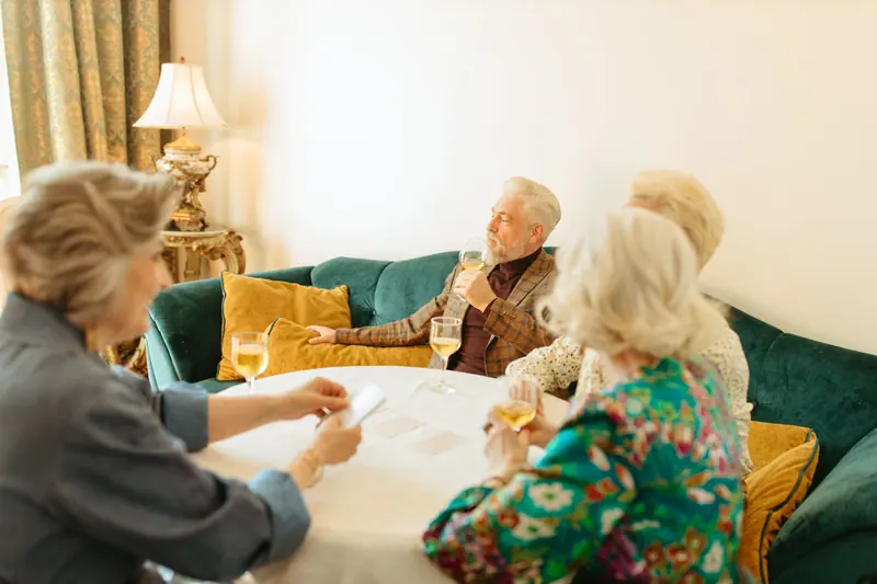 Friends sharing wine in the parlor