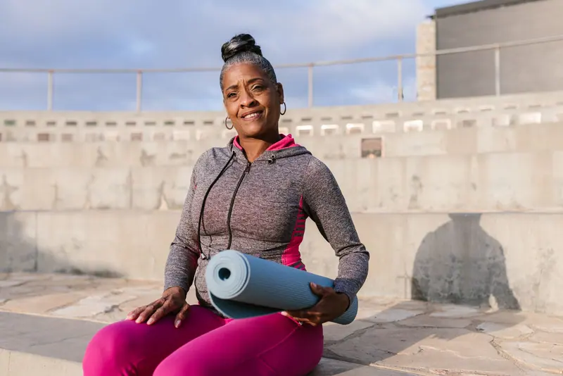 A resident resting with her yoga mat