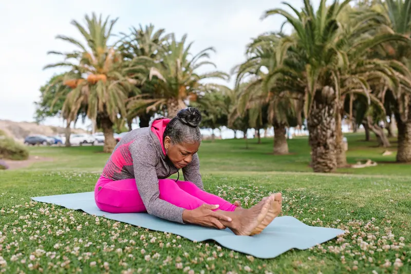 A resident doing yoga in the garden