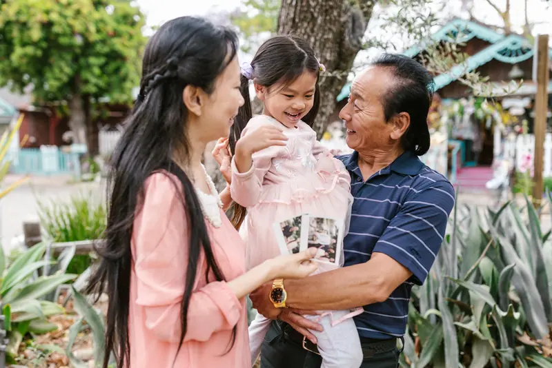 Grandparents with their grandchild outdoors