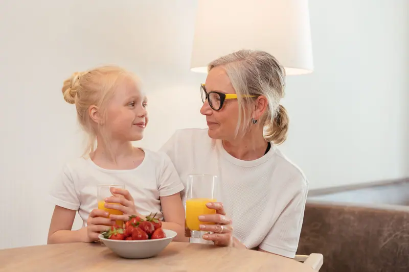 A grandmother and granddaughter with strawberries