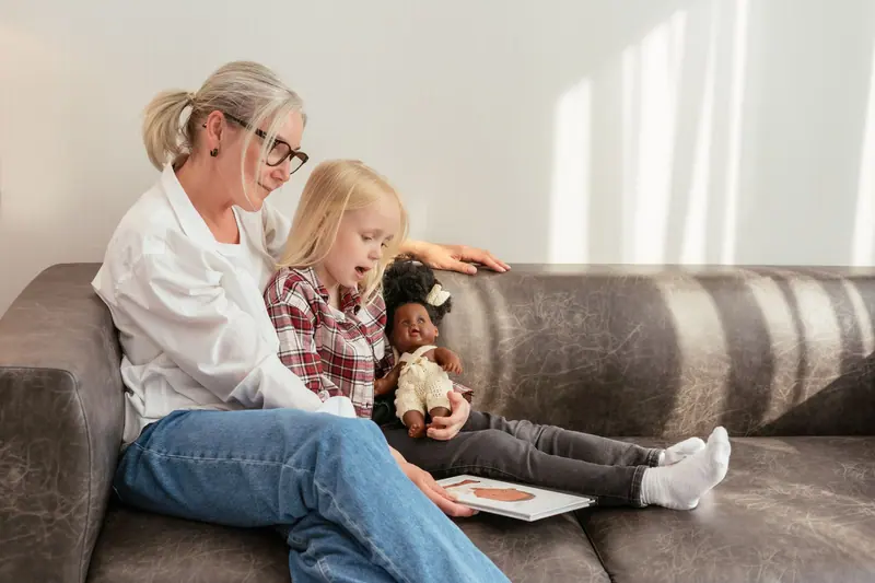 A grandmother reading with her granddaughter