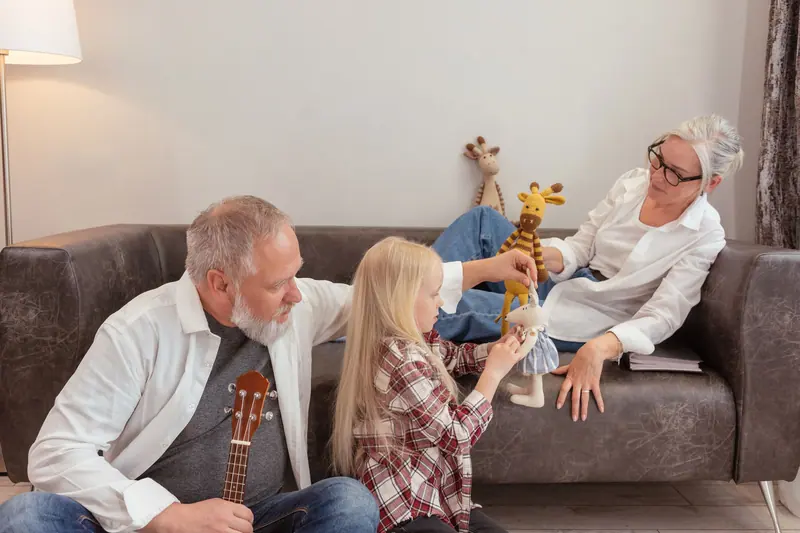 Grandparents playing with their granddaughter