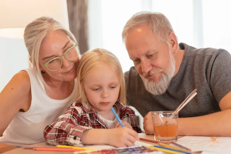 Grandparents drawing with their granddaughter