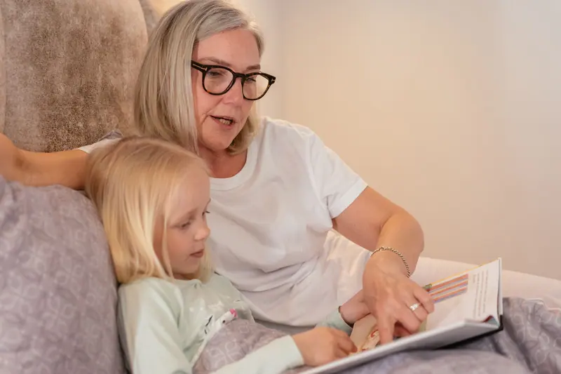A grandmother and granddaughter reading