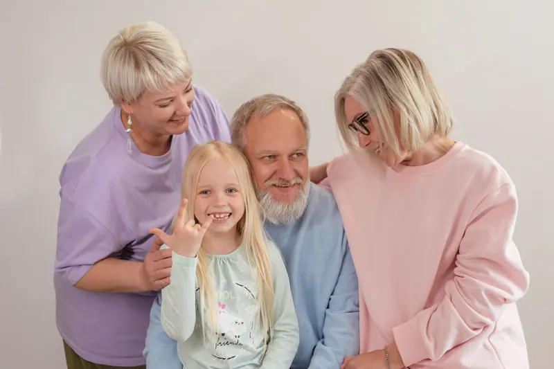 A family gathered around Grandpa on a Sunday visit