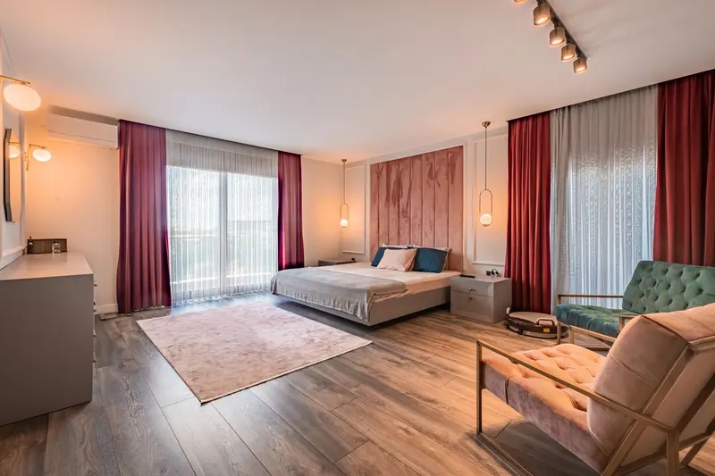 Spacious modern bedroom with stylish decor and cozy atmosphere, perfect for relaxation.