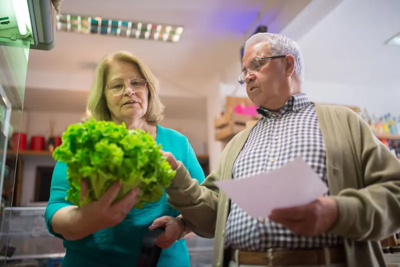 A couple choosing lettuce