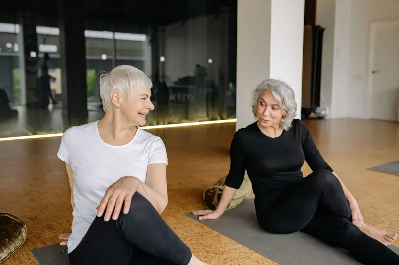 Two residents stretching in the morning fitness class