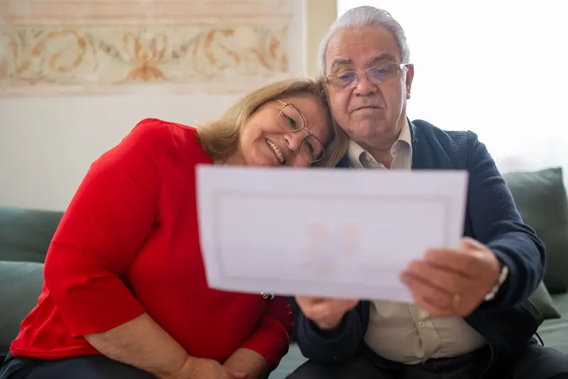 A couple reading a card from the grandchildren