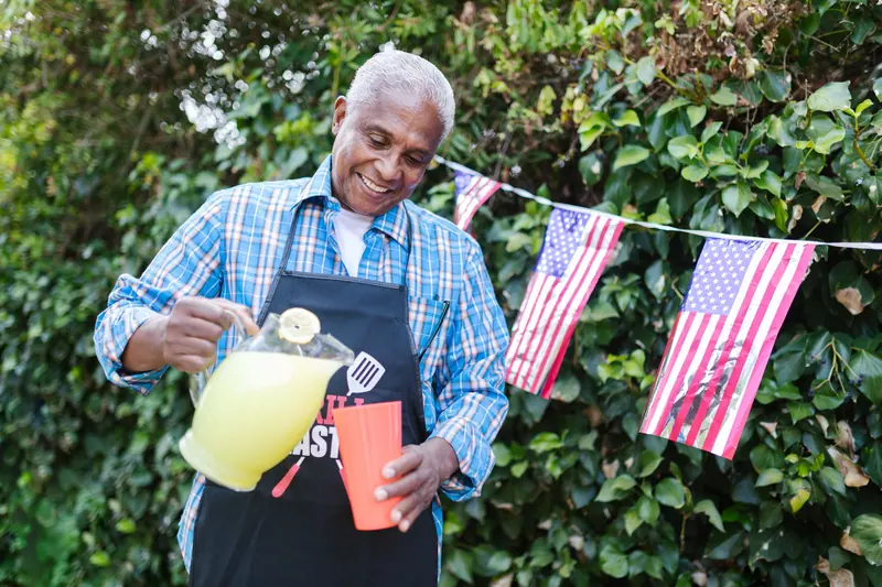 A resident pouring lemonade for the cookout