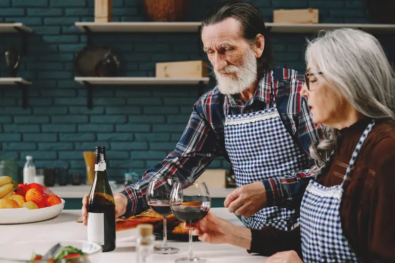 A couple sharing wine in the kitchen