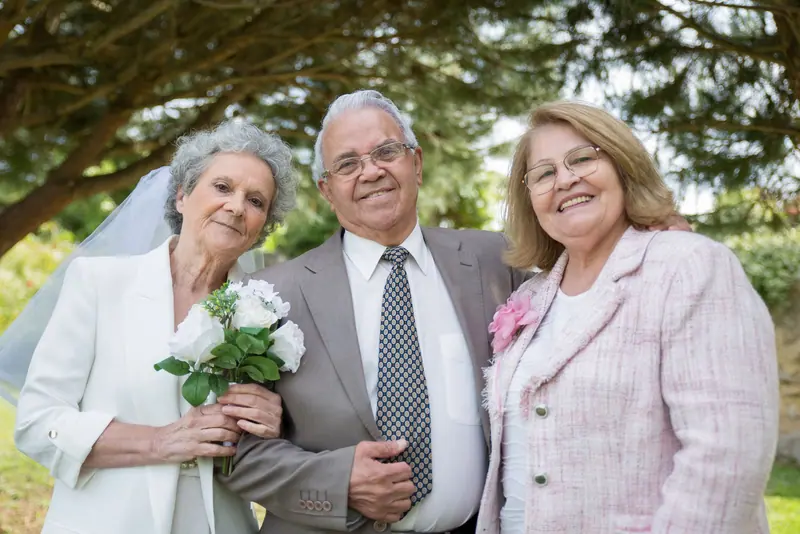 A couple with their daughter after a vow renewal on the lawn