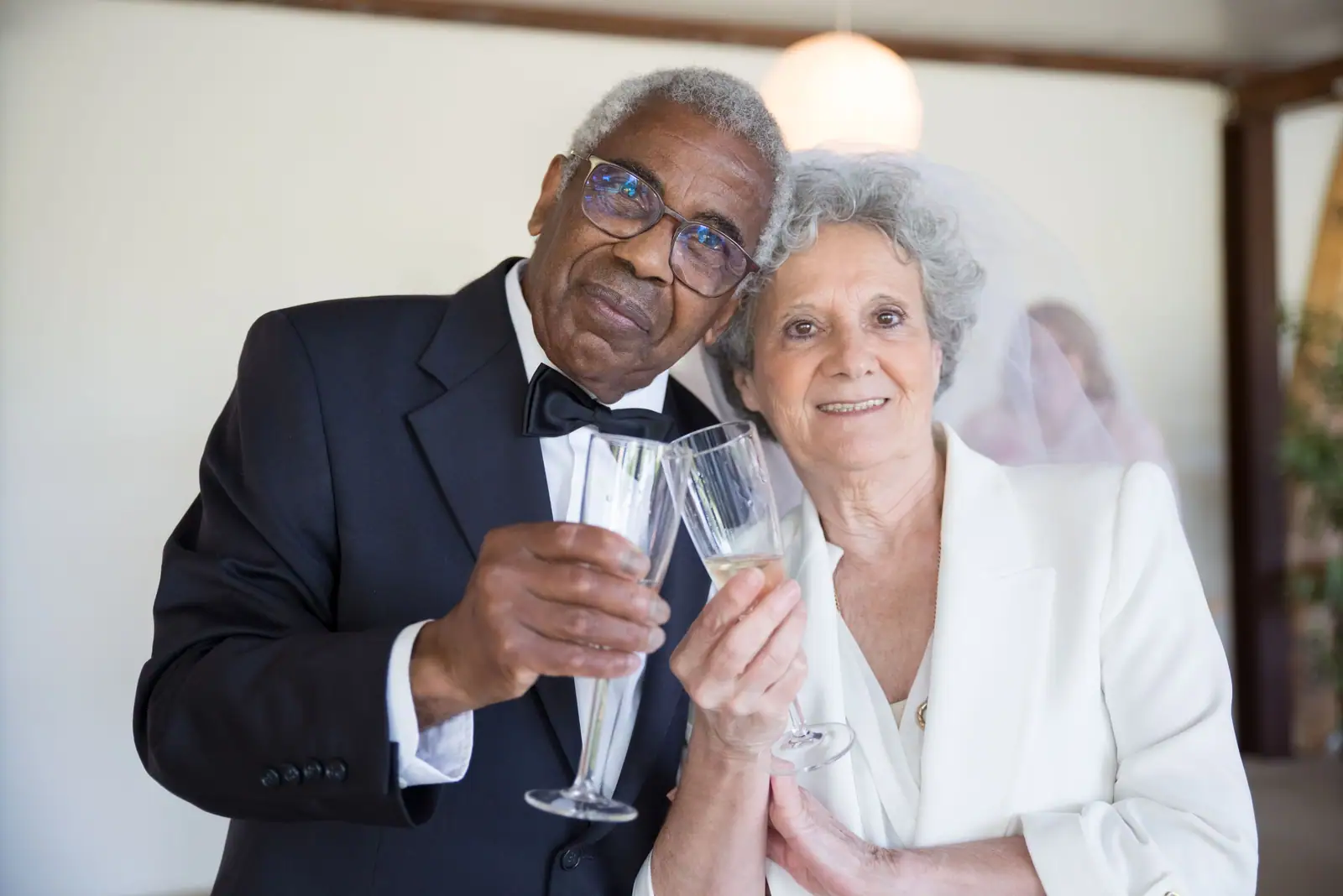 A couple raising a glass at their vow renewal