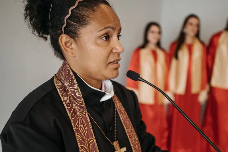 A guest pastor preaching with the choir