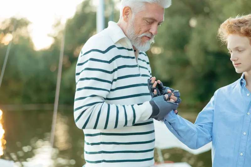A grandfather and grandson by the water