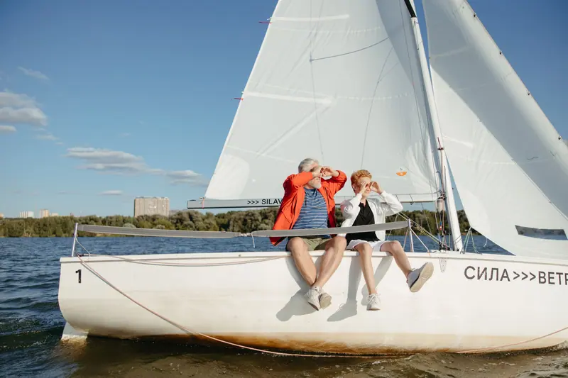 A grandfather and grandson on the sailboat