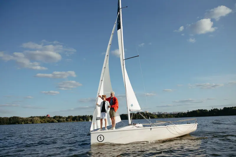 A grandfather and grandson out sailing