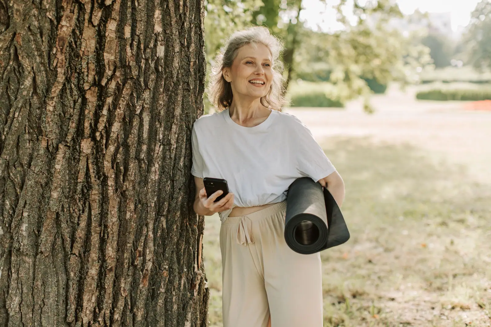 A resident heading to yoga with her mat
