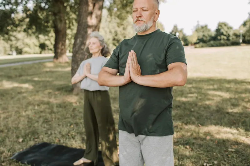 A couple doing tai chi on the lawn