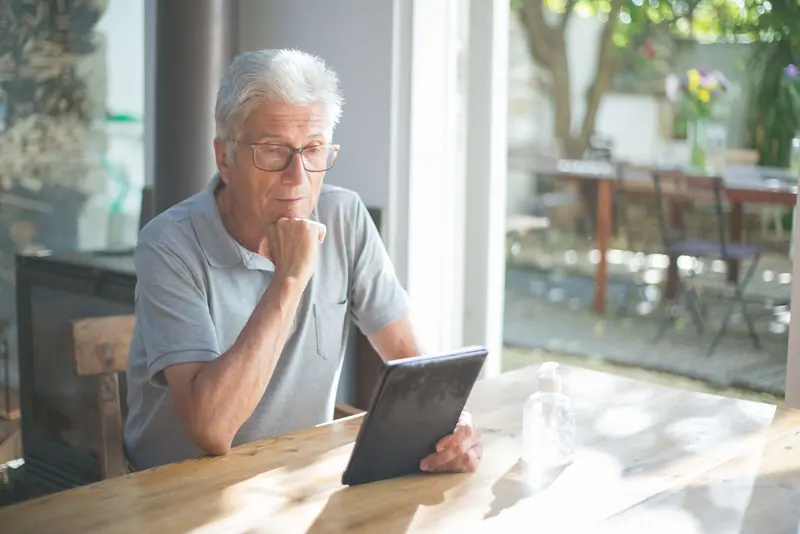 A resident reading on his tablet