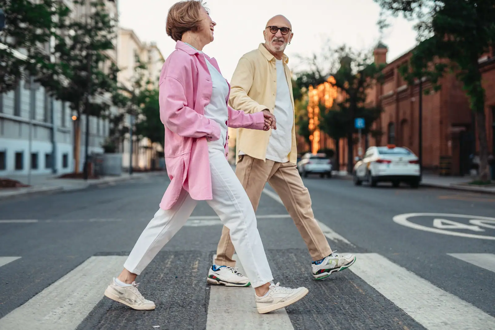 A couple crossing the street hand in hand