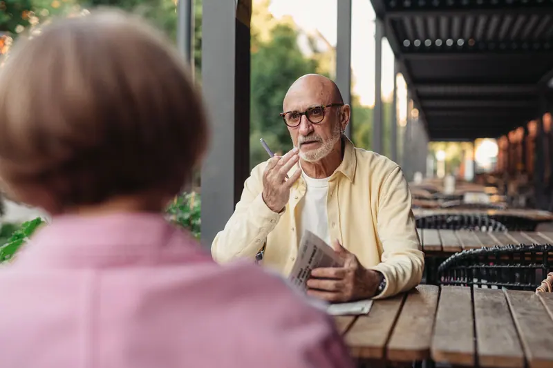 A couple talking over coffee at a sidewalk café