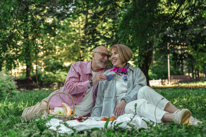 A couple sharing a picnic on the lawn