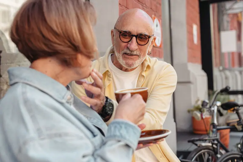 A couple sharing coffee outdoors