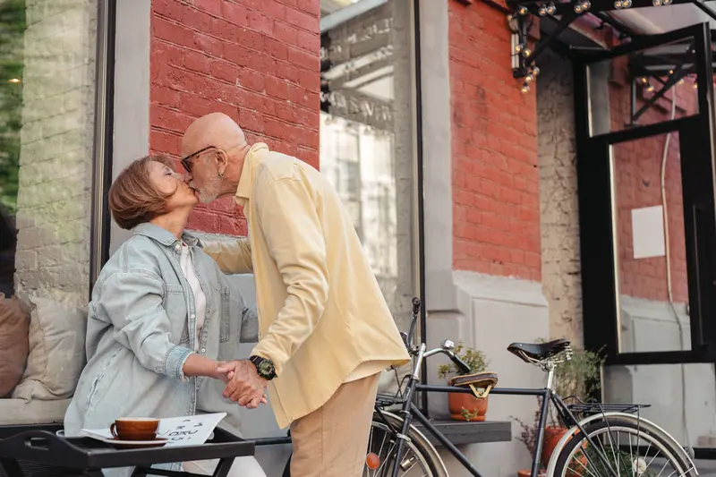 A couple sharing a kiss outside a café