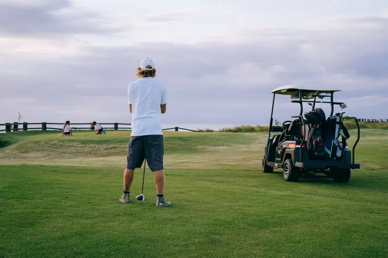 A resident lining up a shot at the golf course