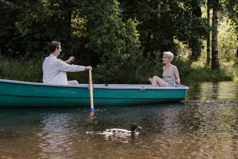 A couple on a boat ride among the trees