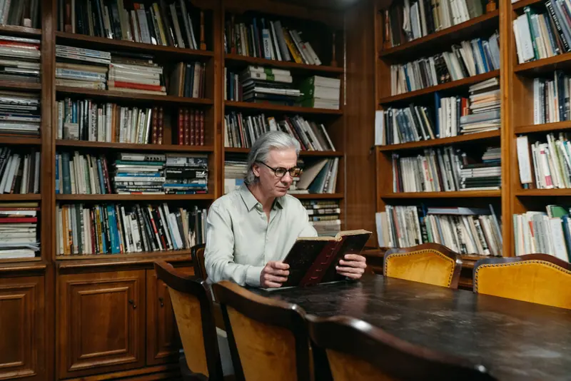 A resident reading among the bookshelves