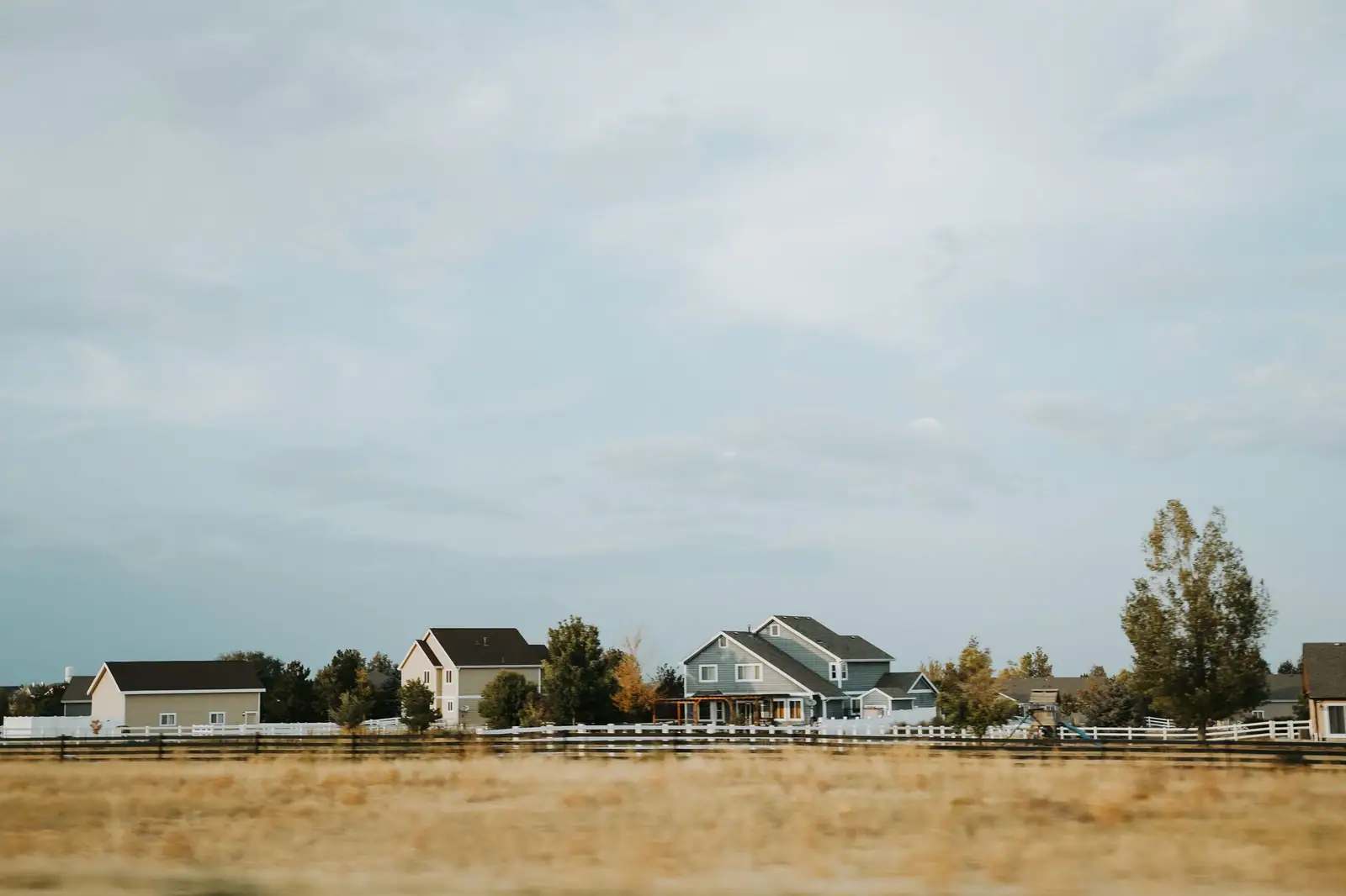 Cottages on the edge of the prairie under a wide Kansas sky
