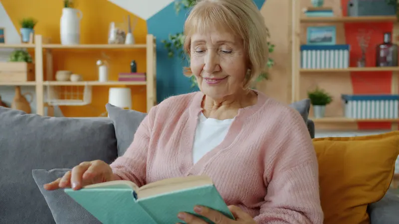 A resident reading in the sunroom