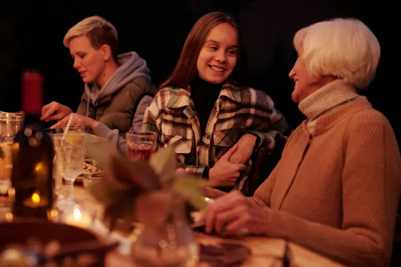 Three generations of women sharing a candlelit supper