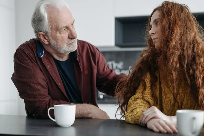 A resident and his daughter over coffee