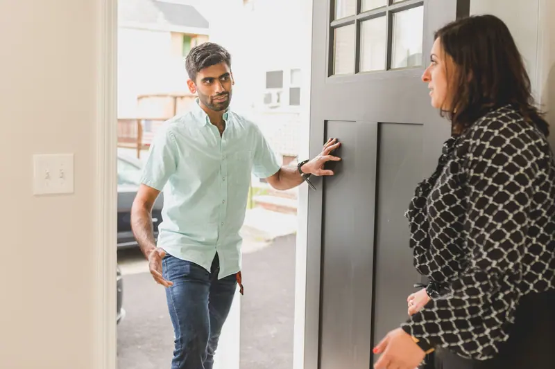 A clinician arriving at a patient's front door for a home visit