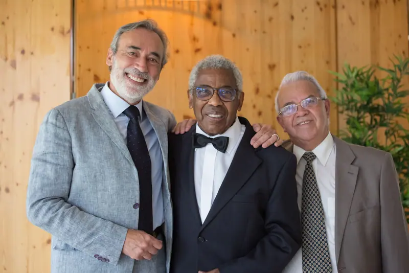 Three residents in their Sunday suits before the anniversary dinner