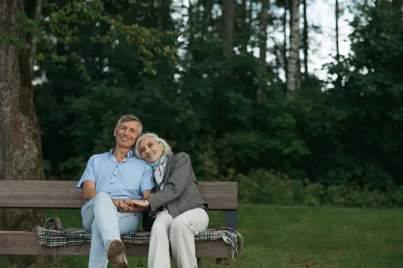An older couple sharing a quiet moment on a park bench