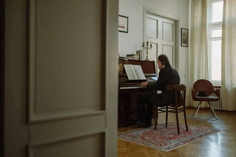A man playing piano in his front room