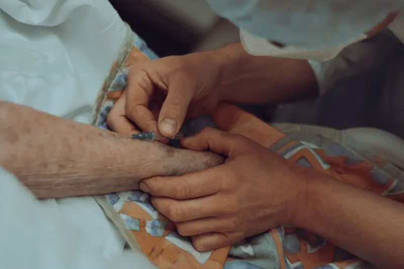 A nurse's hand on a resident's