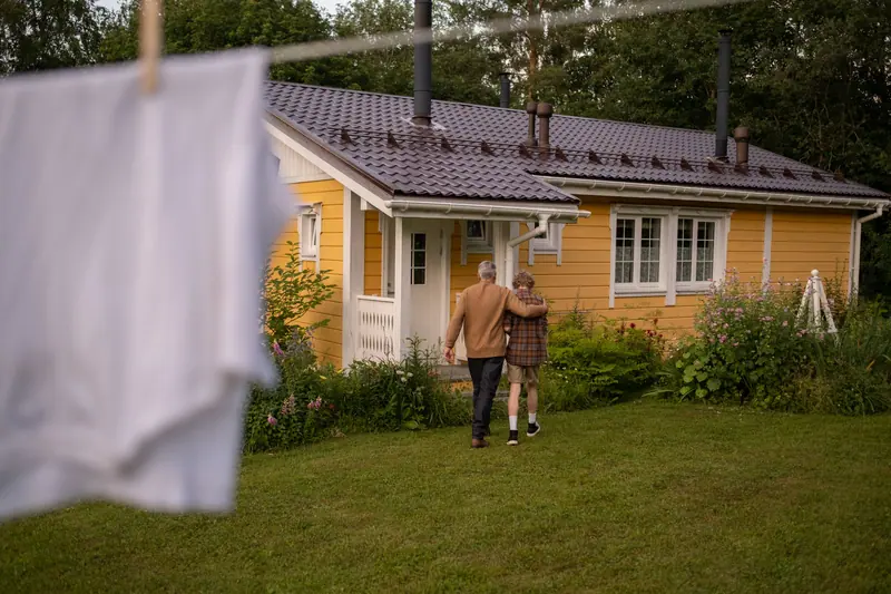 The couple strolling slowly past the clothesline toward home