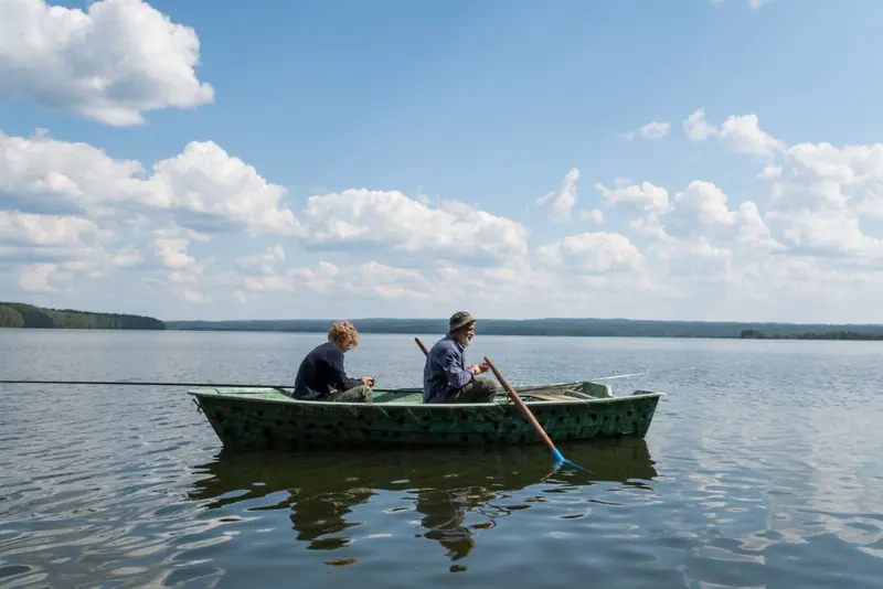 A family fishing from a small boat