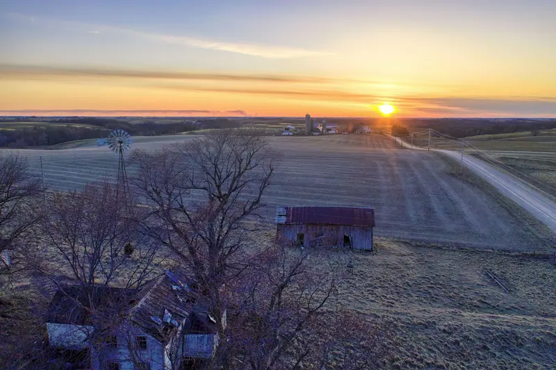 Farm fields rolling to the horizon at sunset