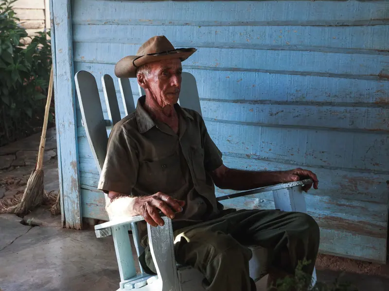 A rancher in a rocking chair on the porch