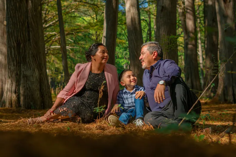 A family sitting together among the trees