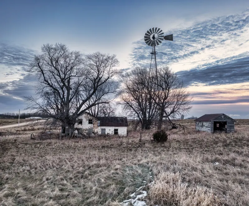 A barn and windmill in winter